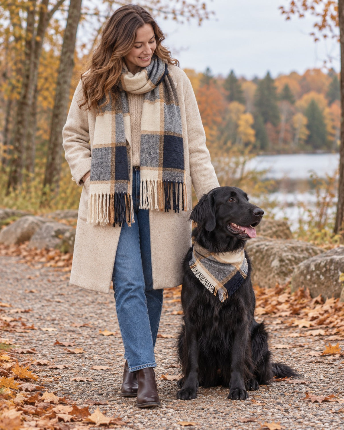 Woman wearing the Lakeside Plaid fringed scarf beside a dog wearing the matching fringed pet bandana.